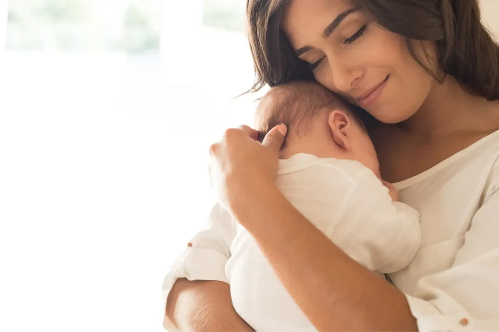 Intended parents embracing after learning about Tandem Surrogacy’s screening and matching process