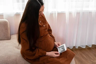 Gestational carrier resting comfortably, representing thoughtful and respectful surrogate compensation